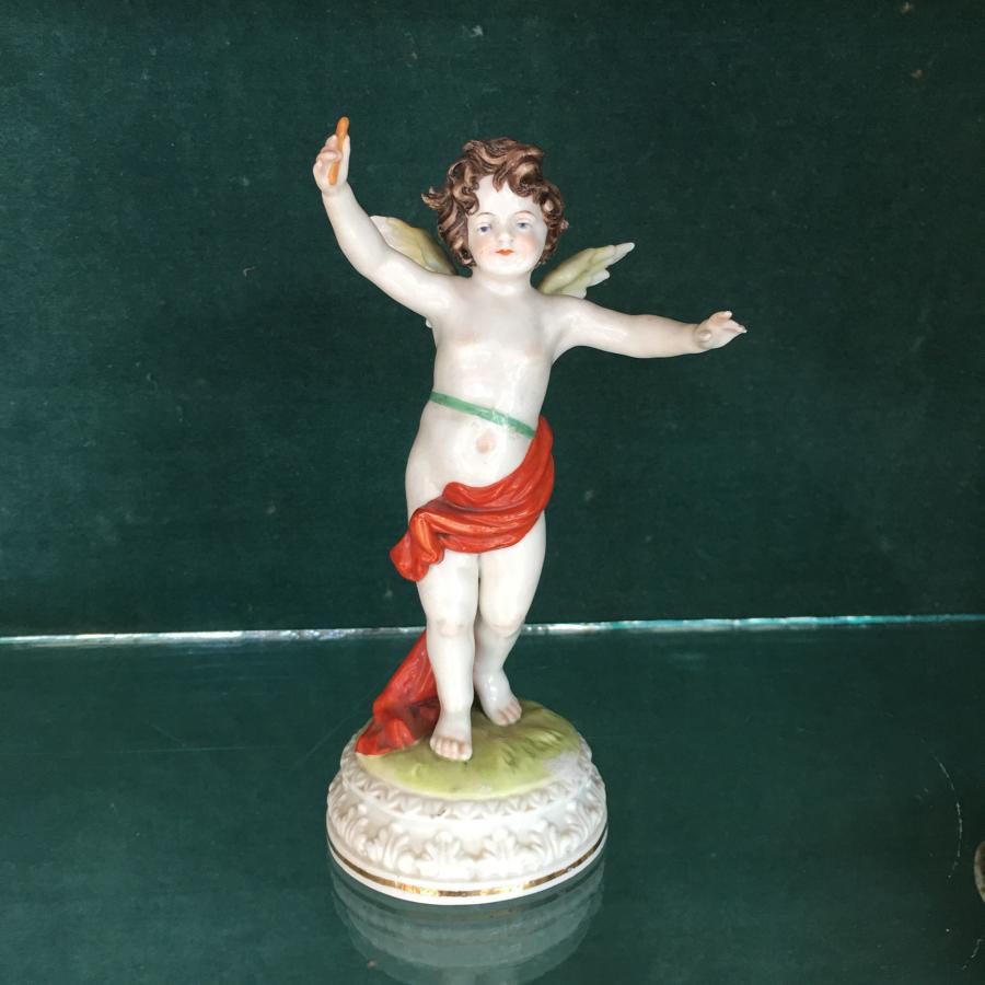 Porcelain cherub figure