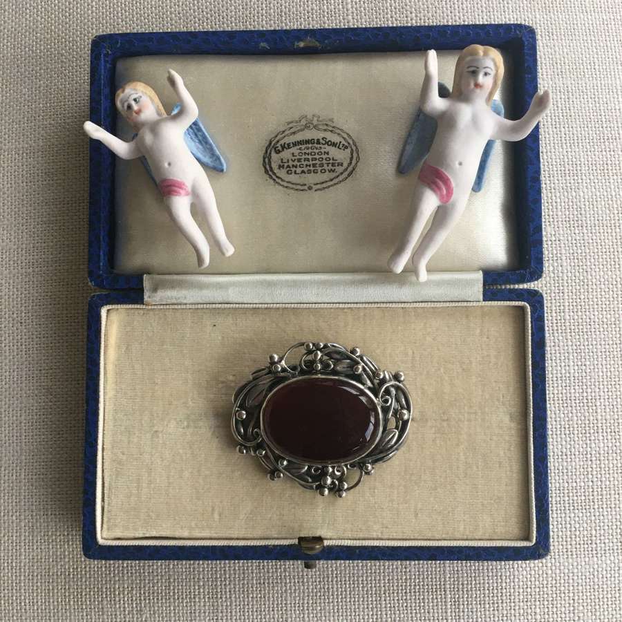 Cranberry glass and silver brooch