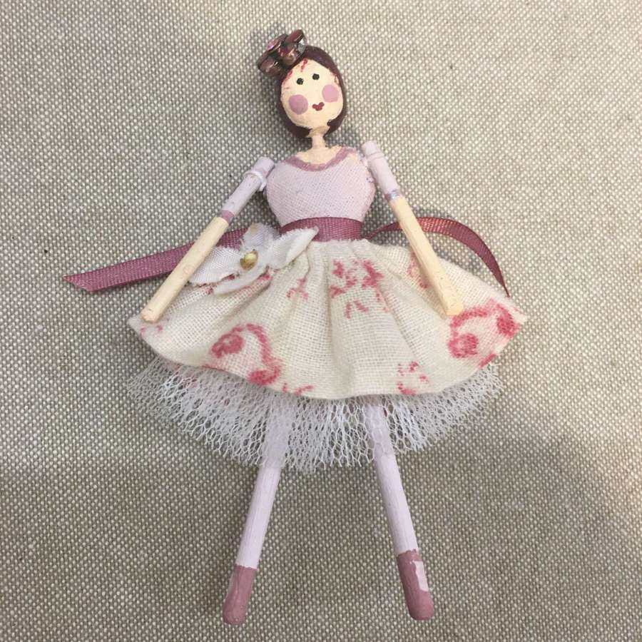 Tiny paper clay doll with vintage fabric dress