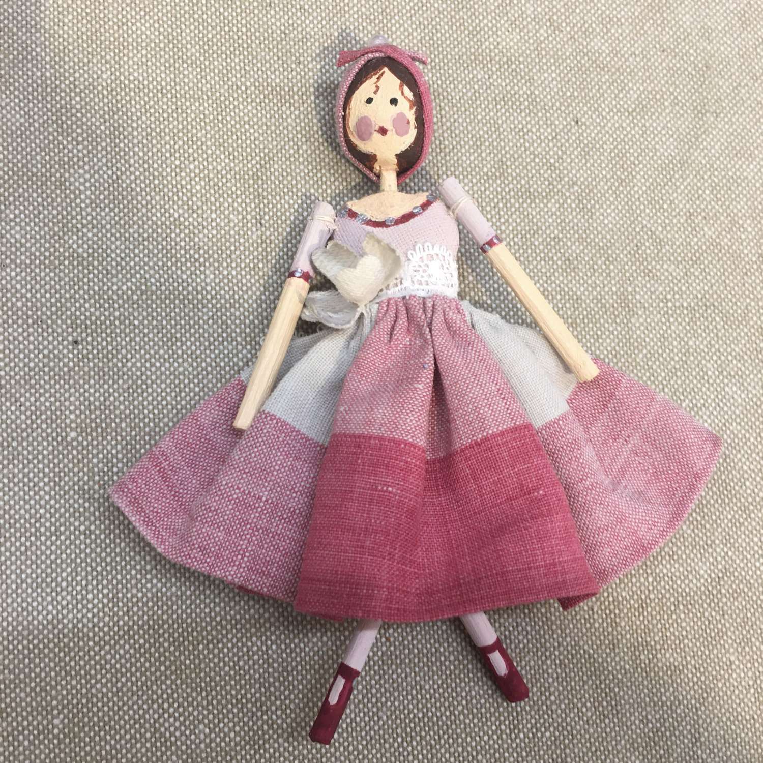 A tiny fairy doll handmade from paper clay with vintage fabrics