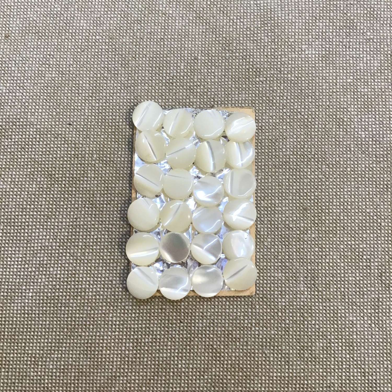 24 small mother of pearl buttons 0.7cm diameter