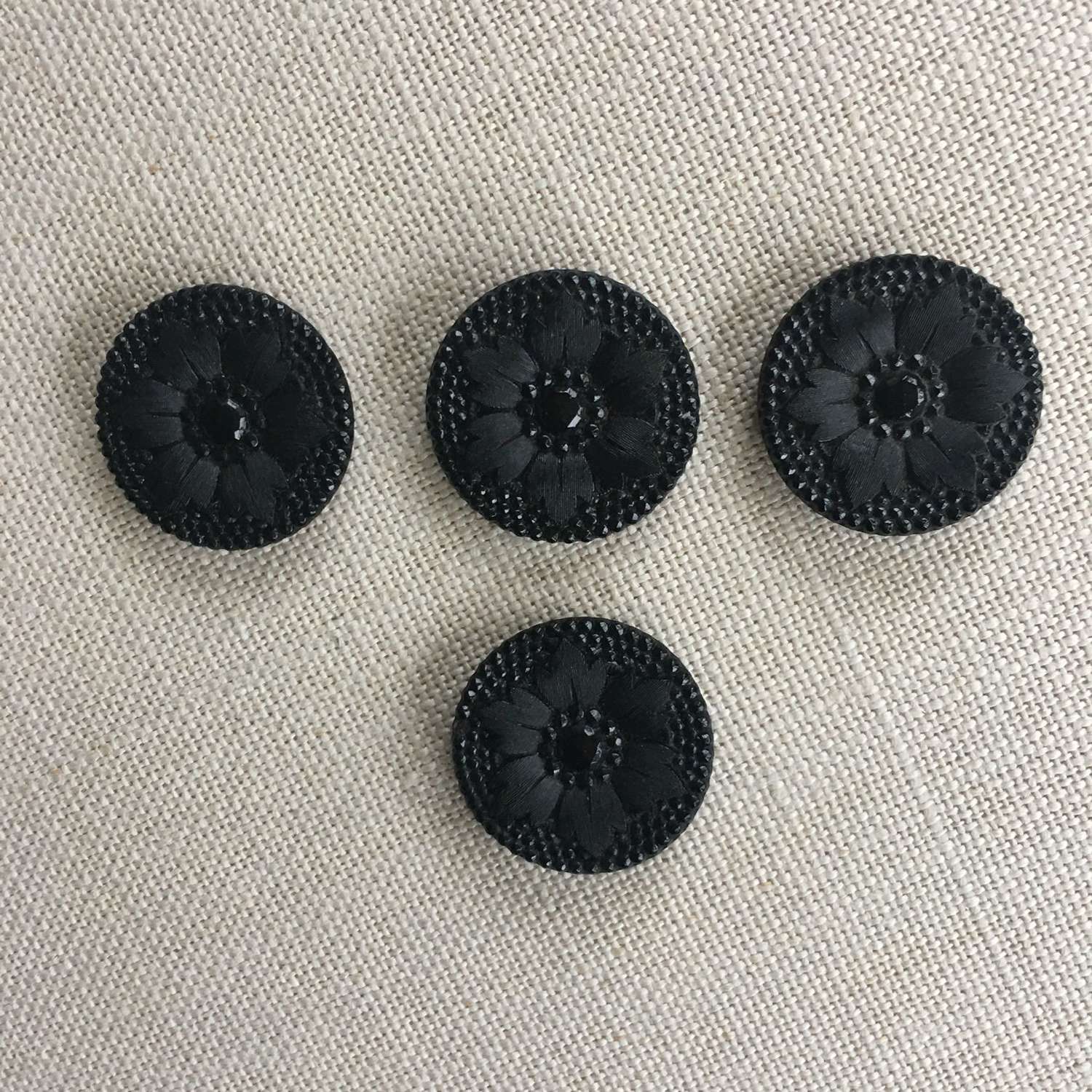 Four Victorian black flower buttons