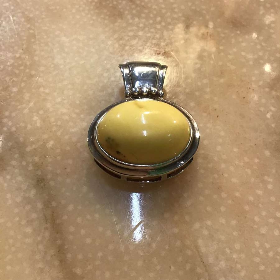 Hallmarked silver and white amber pendant