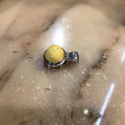 Hallmarked silver and white amber pendant