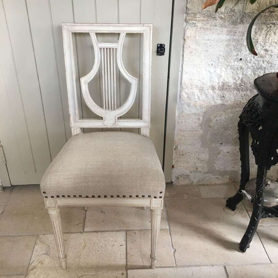 A pair of French antique 1920s painted lyre back chairs