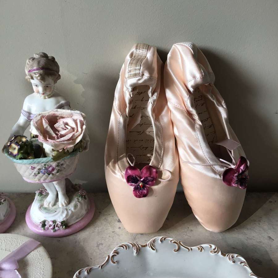 Decorated pink ballet shoes embellished with flowers