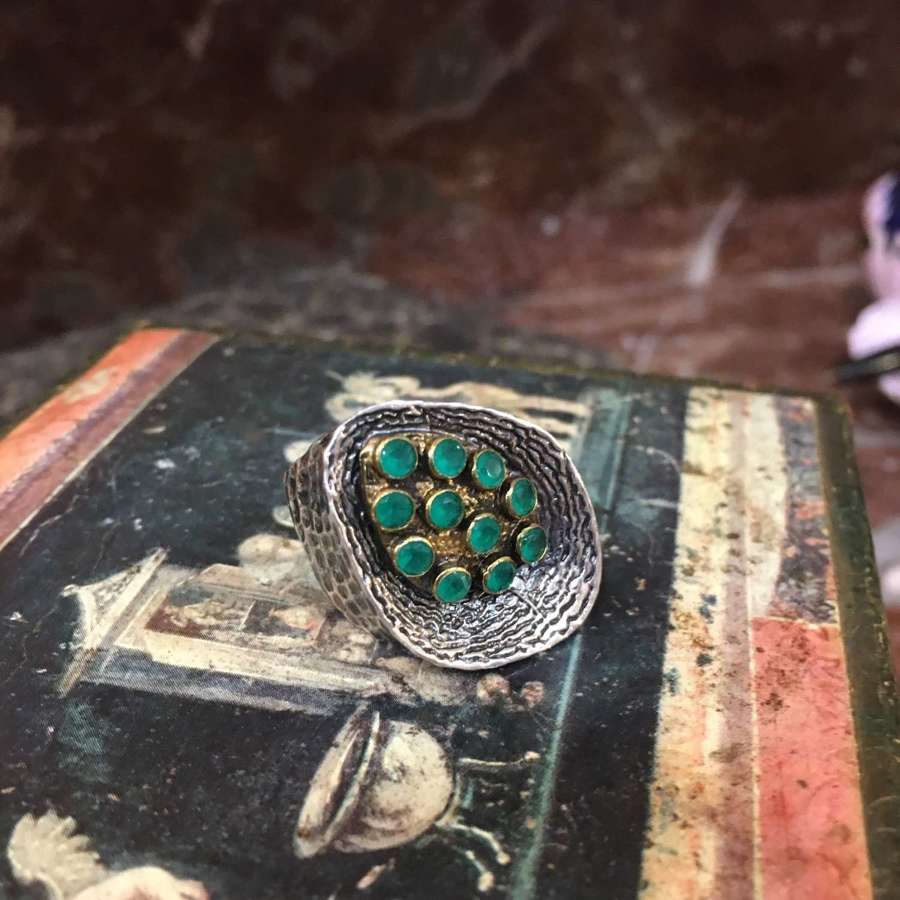 Sterling silver ring with gold plated section inset with green stones