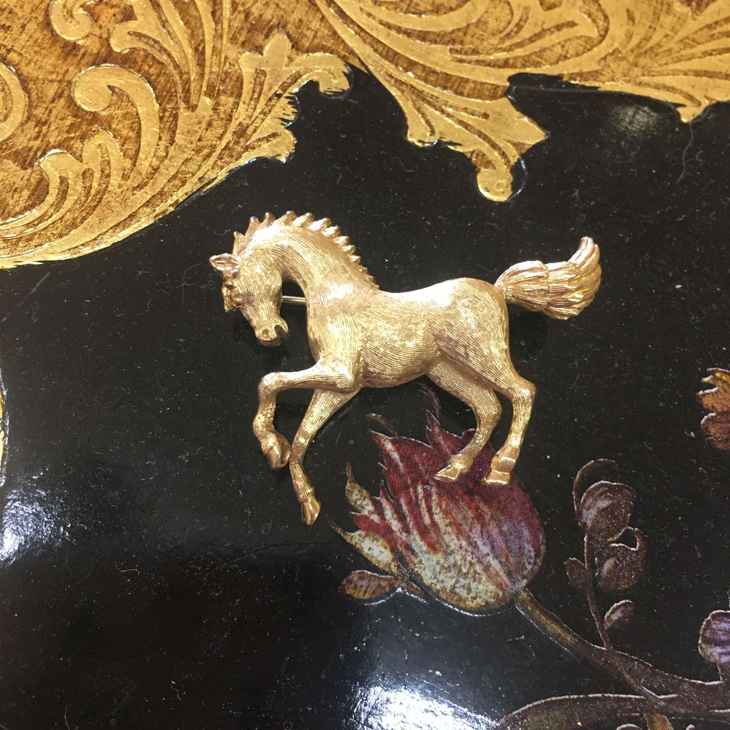 Vintage Monet gold tone horse brooch