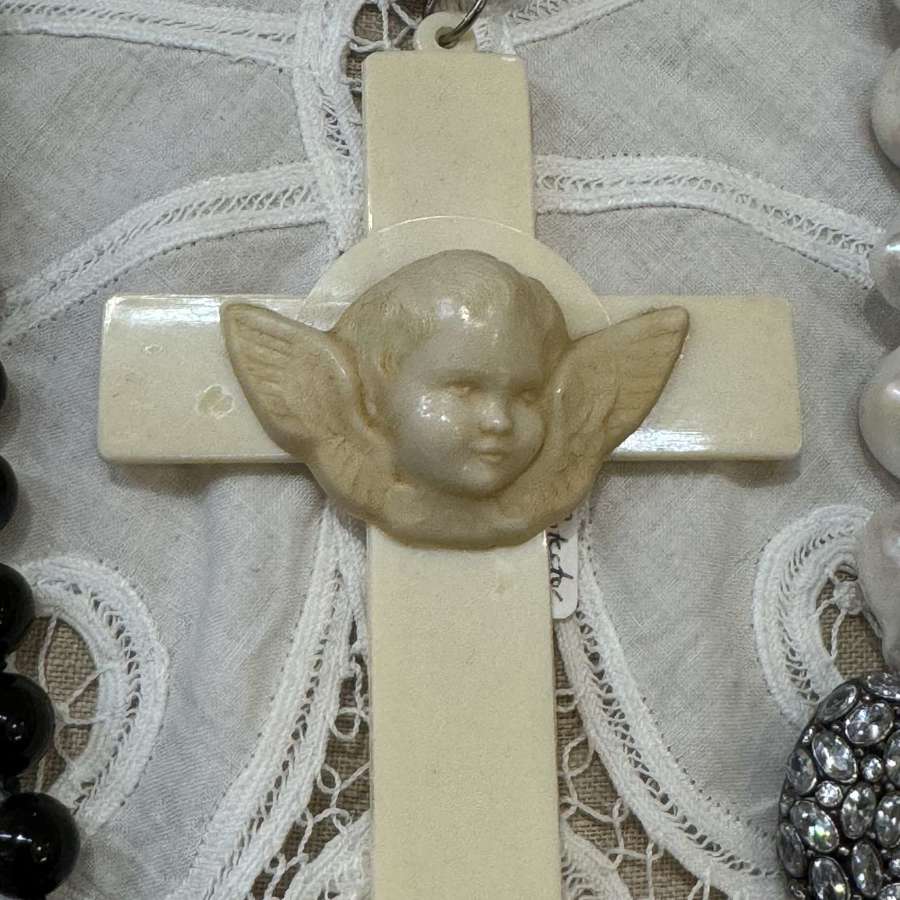 1920s celluloid cot protector cross with central angel head