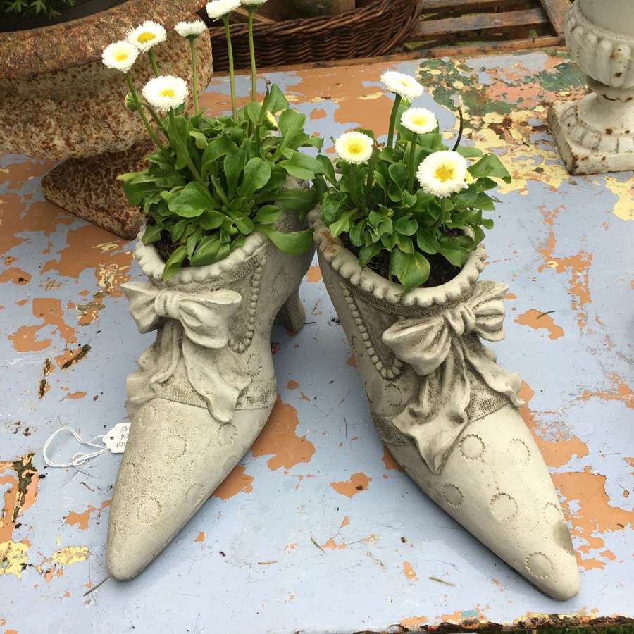A pair of decorative ladies shoe garden planters